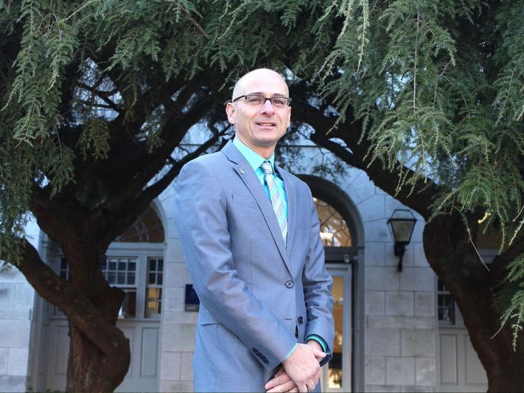 Gary Liquori standing in front of a building